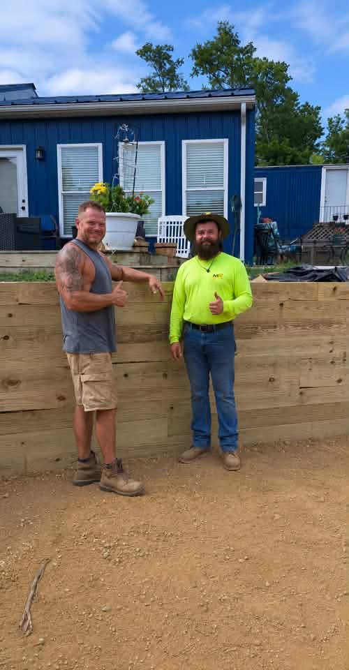Father and son crew of MX Property Services standing by a timber retaining wall in Northern Kentucky