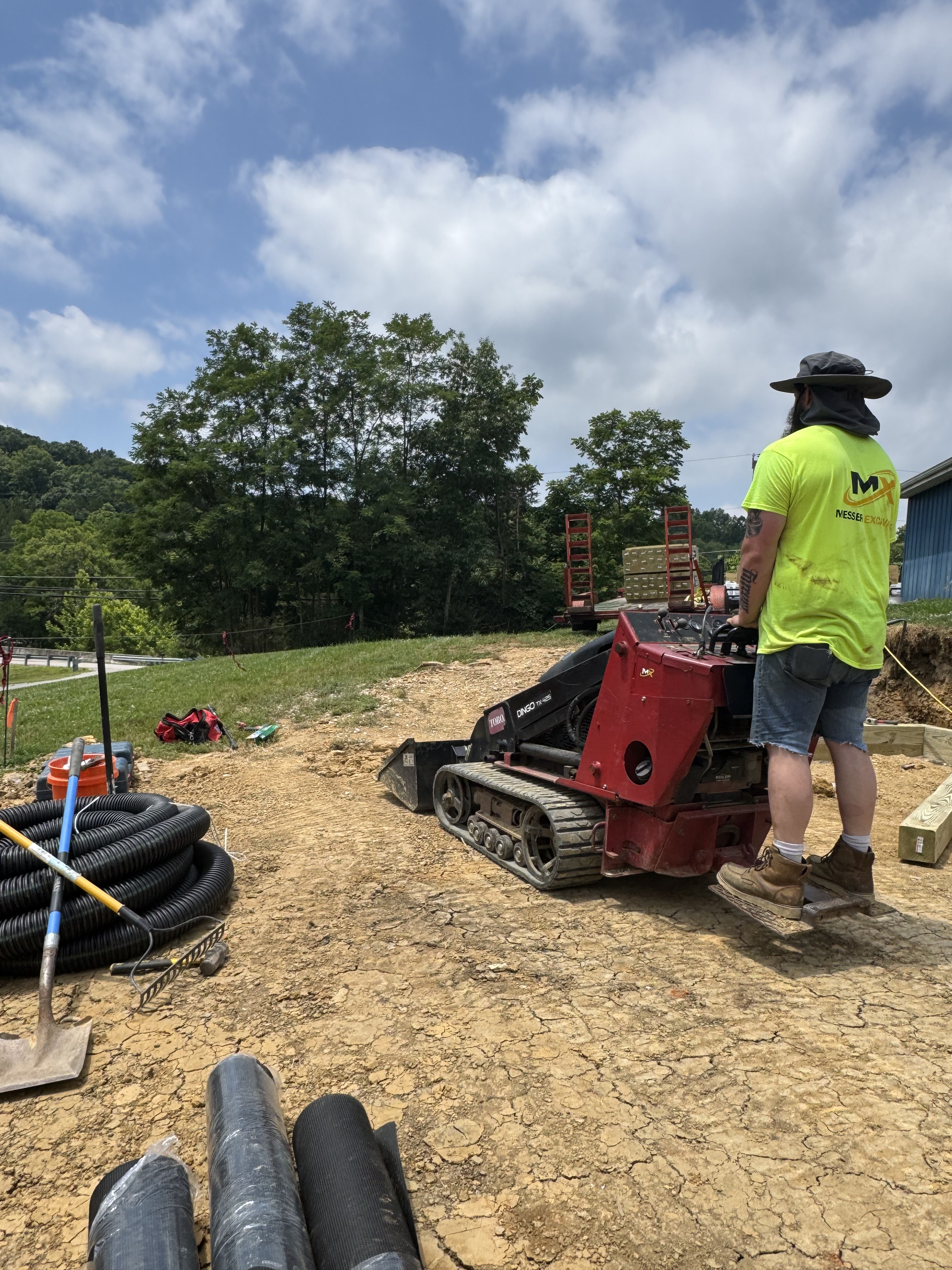 MX Property Services crew running a Toro Dingo mini skid steer during gravel pad site prep in Northern Kentucky