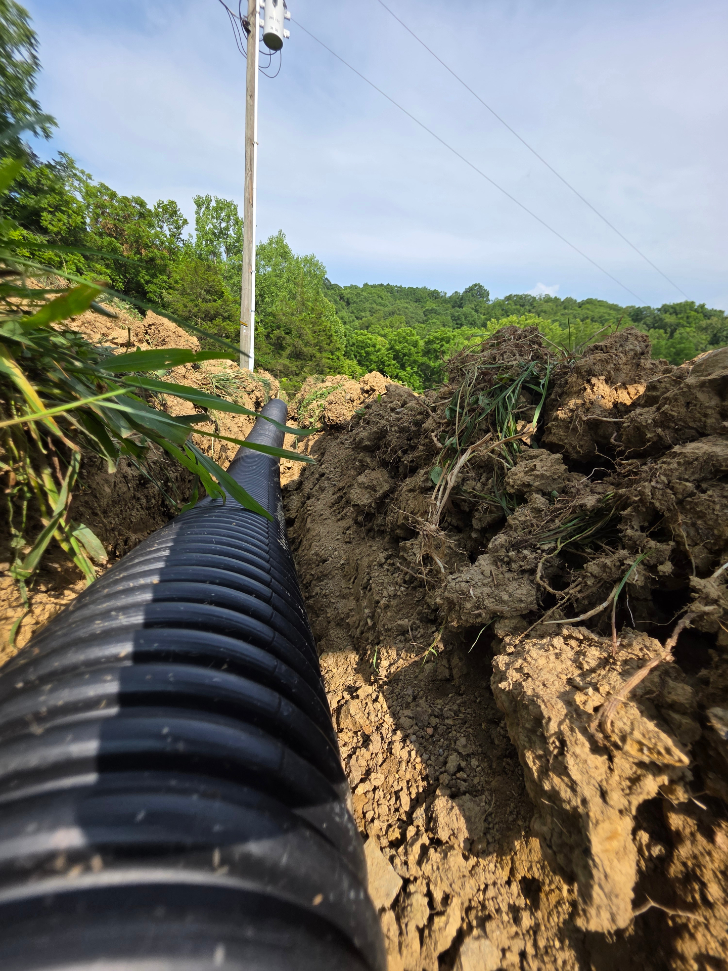 Corrugated drainage pipe laid in trench along a hillside in Northern Kentucky