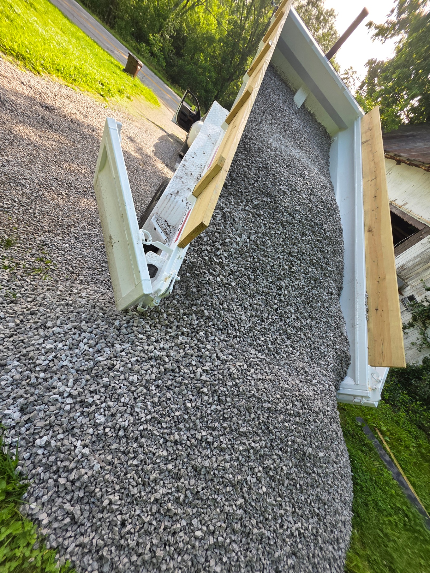 MX Property Services dump truck spreading gravel on a driveway in Alexandria KY