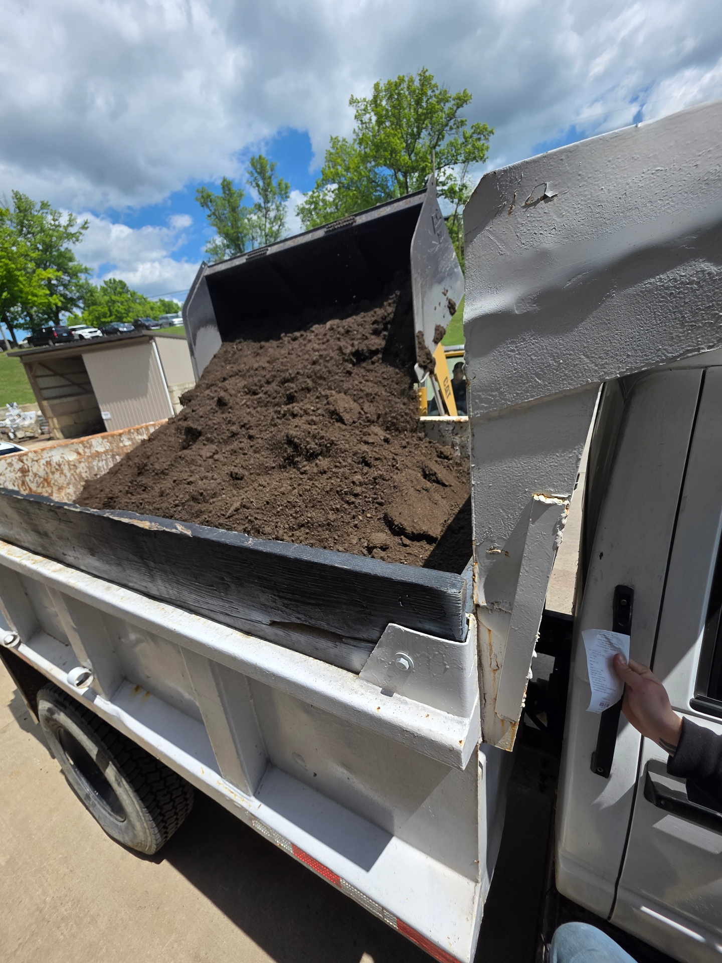 Topsoil being loaded into MX Property Services dump truck for delivery in NKY